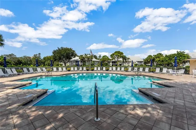 a view of a swimming pool and a yard