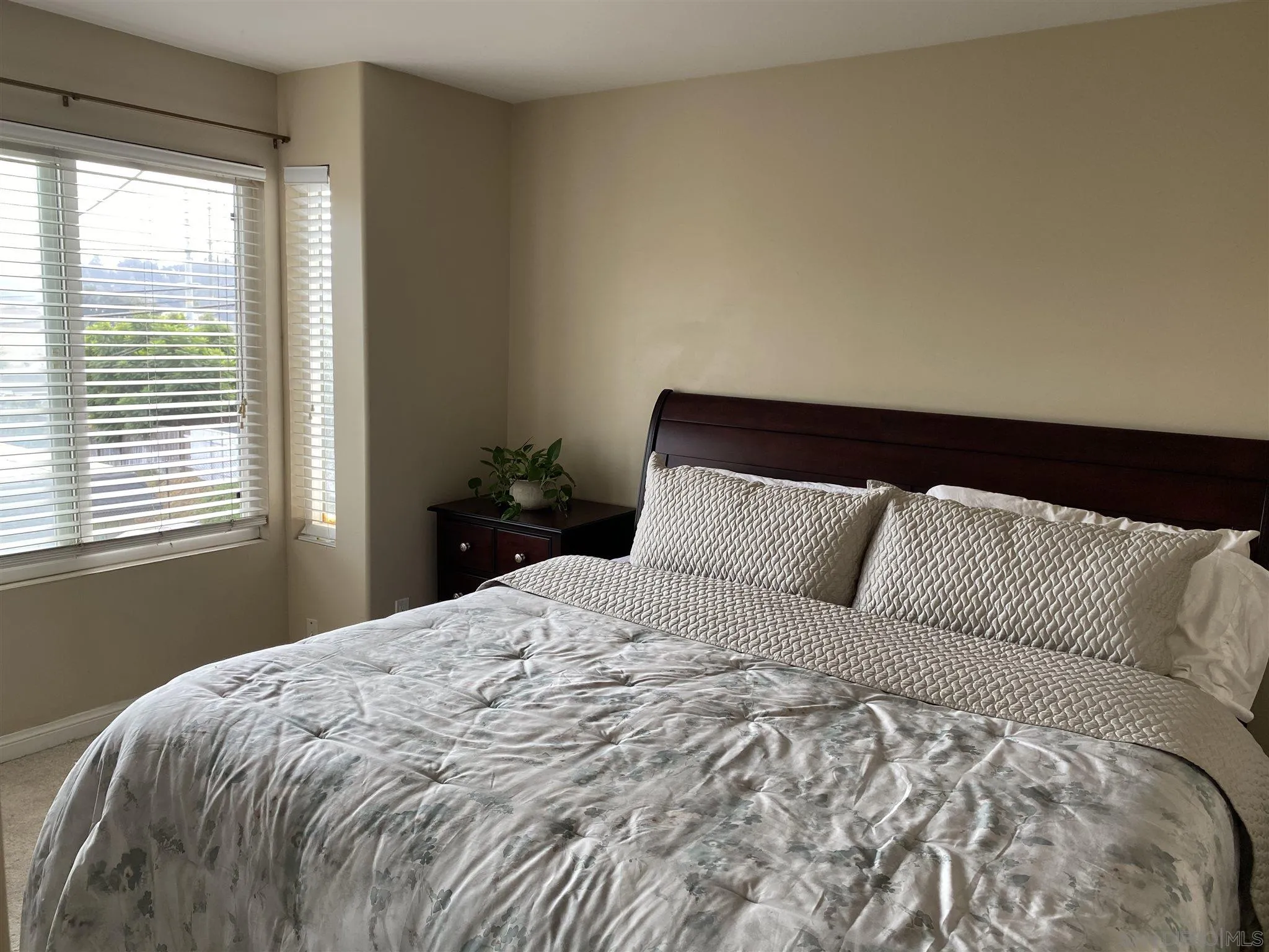 5722 Riley Street, Unit 3 San Diego, CA 92110 - Photo 11 of 14 a large bed sitting in a bedroom next to a window
