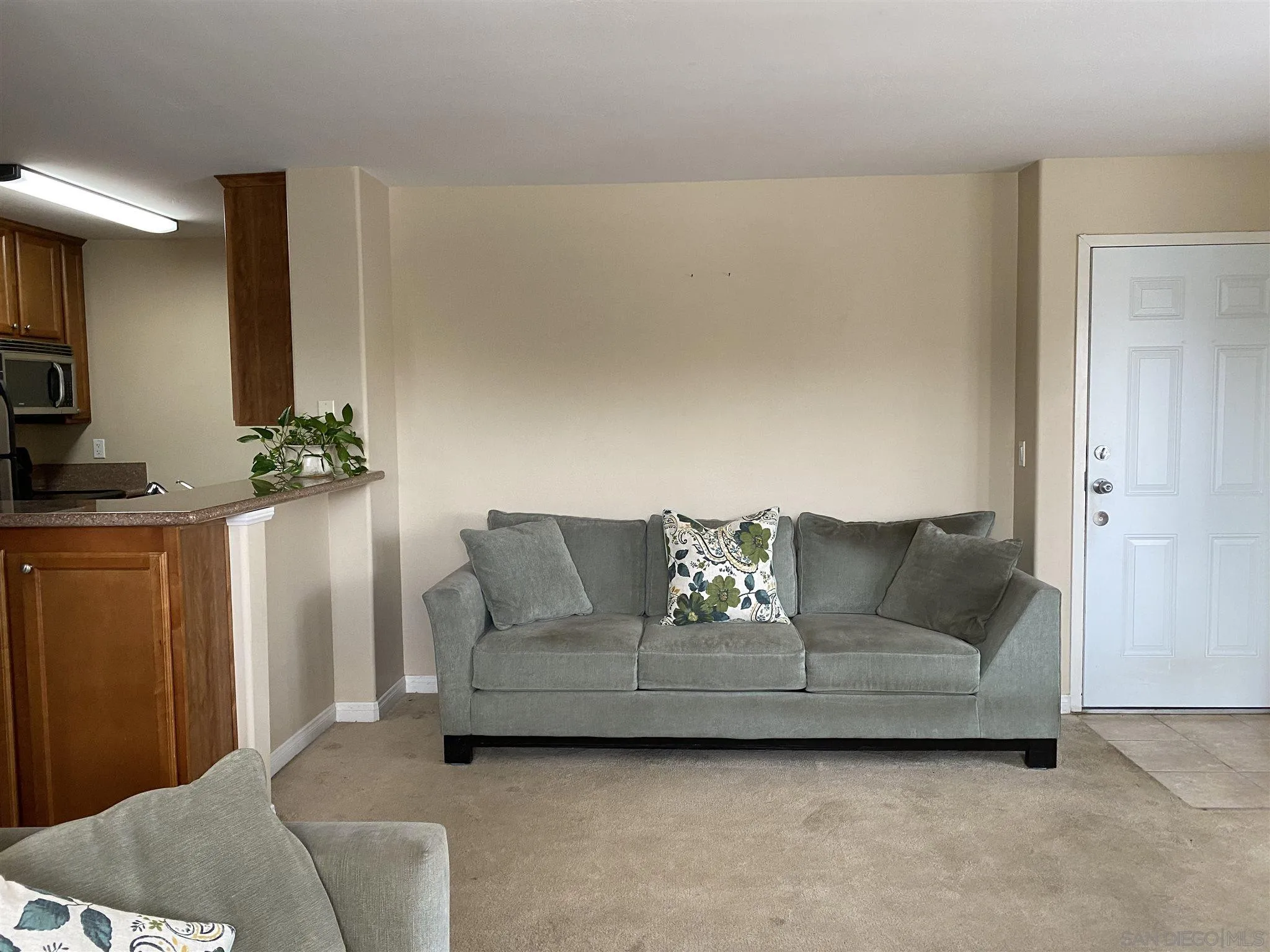 5722 Riley Street, Unit 3 San Diego, CA 92110 - Photo 2 of 14 a living room with furniture and a flat screen tv