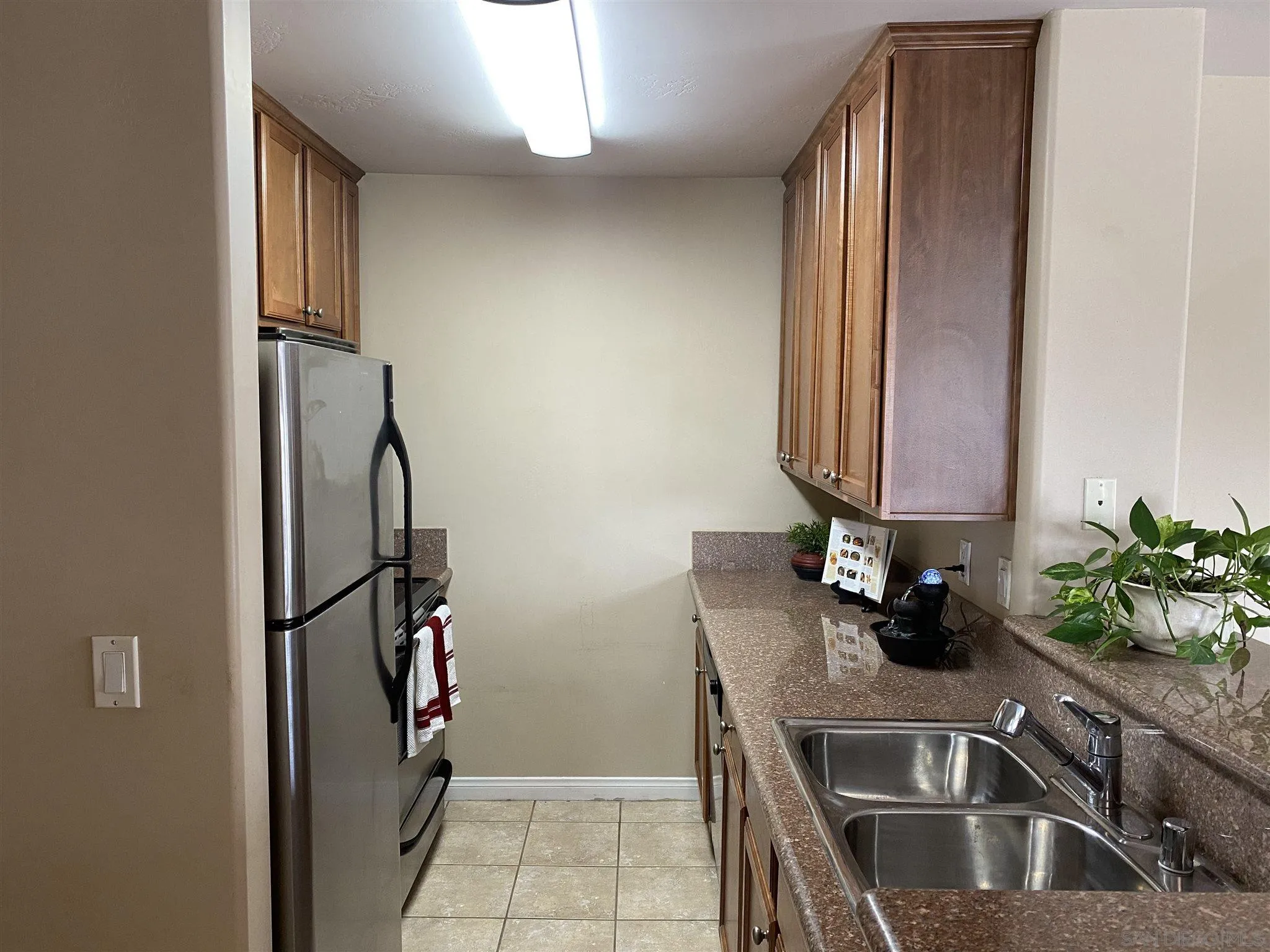 5722 Riley Street, Unit 3 San Diego, CA 92110 - Photo 5 of 14 a kitchen with a sink and a refrigerator