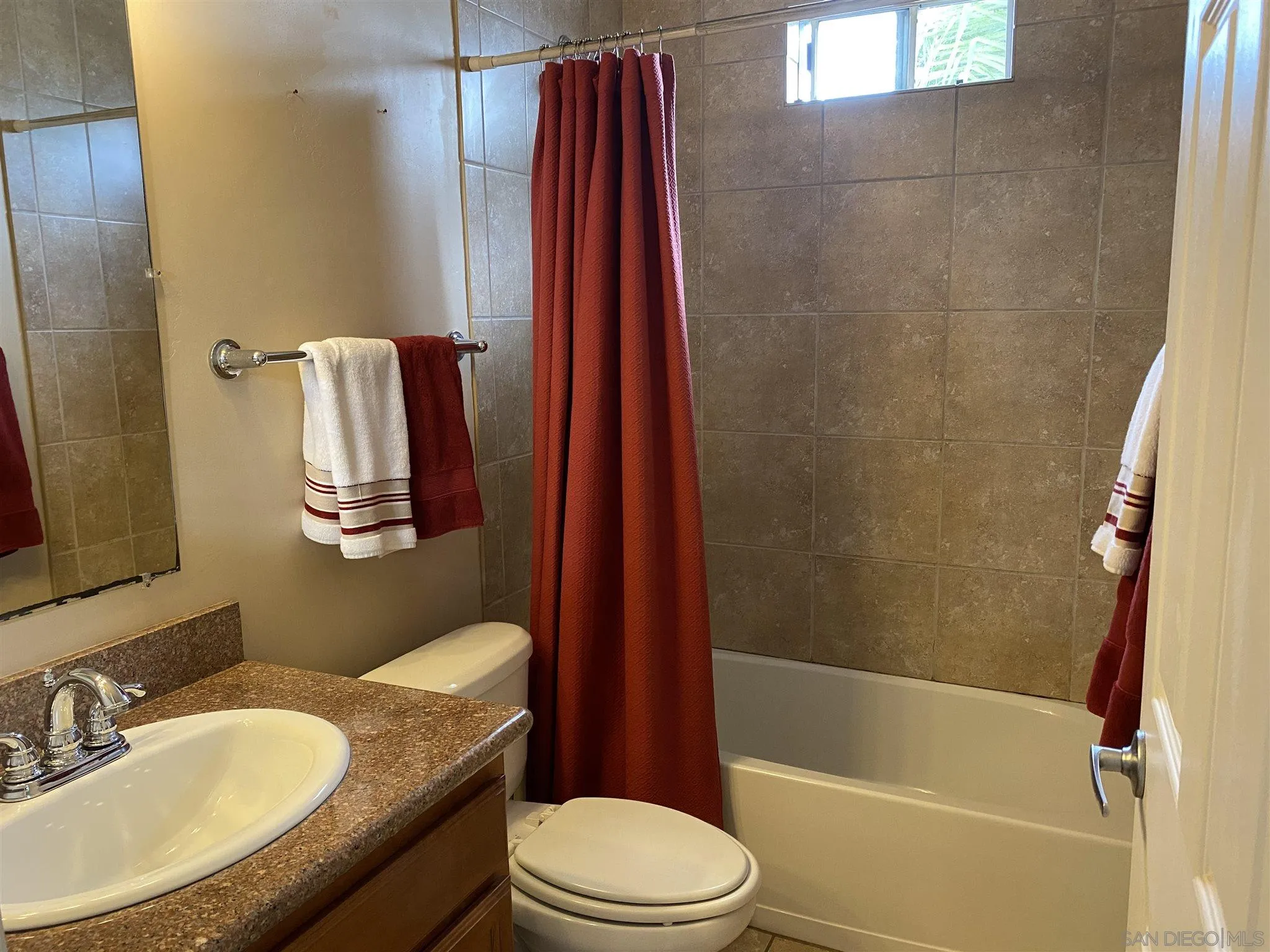 5722 Riley Street, Unit 3 San Diego, CA 92110 - Photo 7 of 14 a bathroom with a granite countertop toilet sink and shower