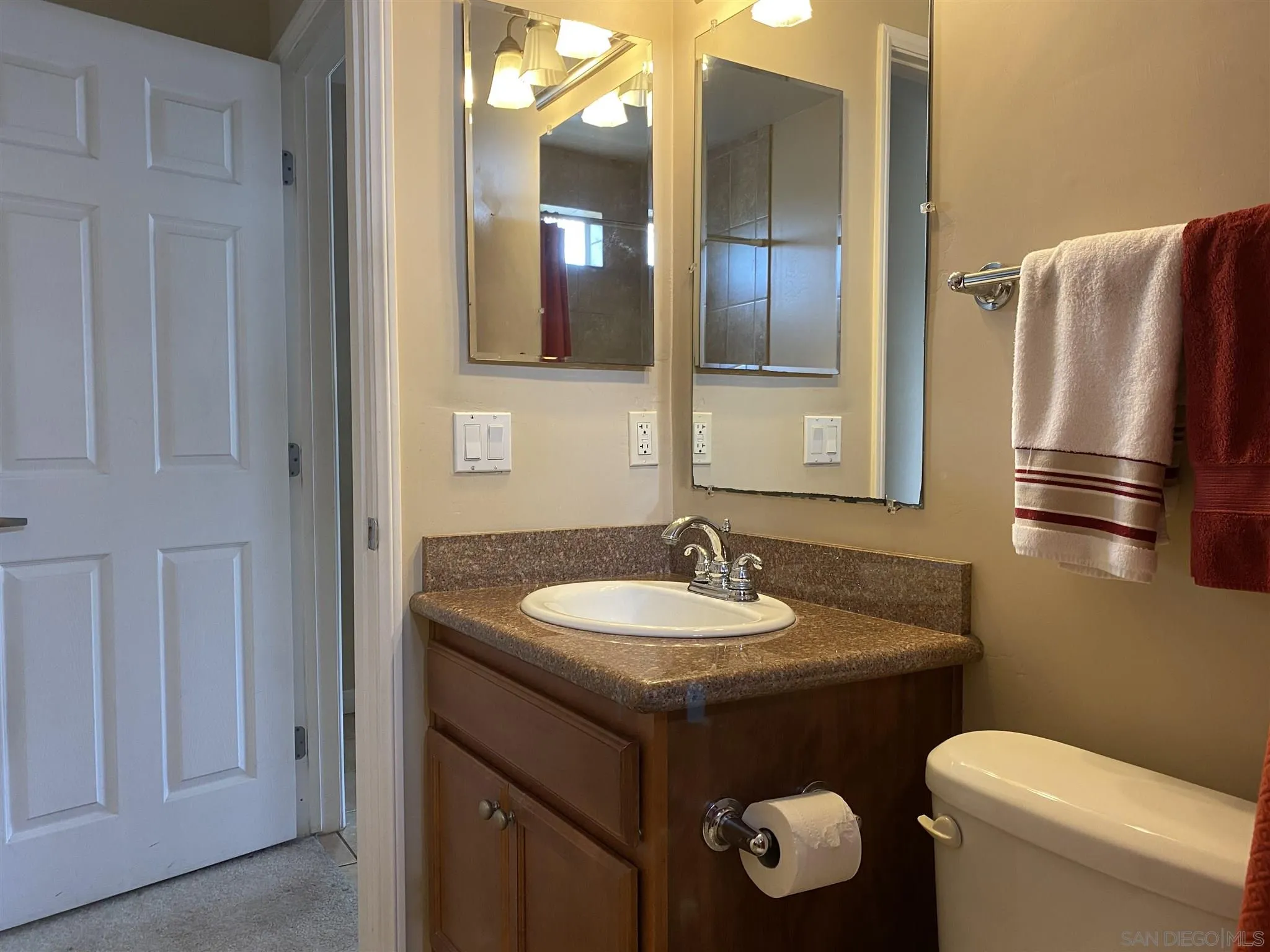 5722 Riley Street, Unit 3 San Diego, CA 92110 - Photo 8 of 14 a bathroom with a toilet sink and mirror
