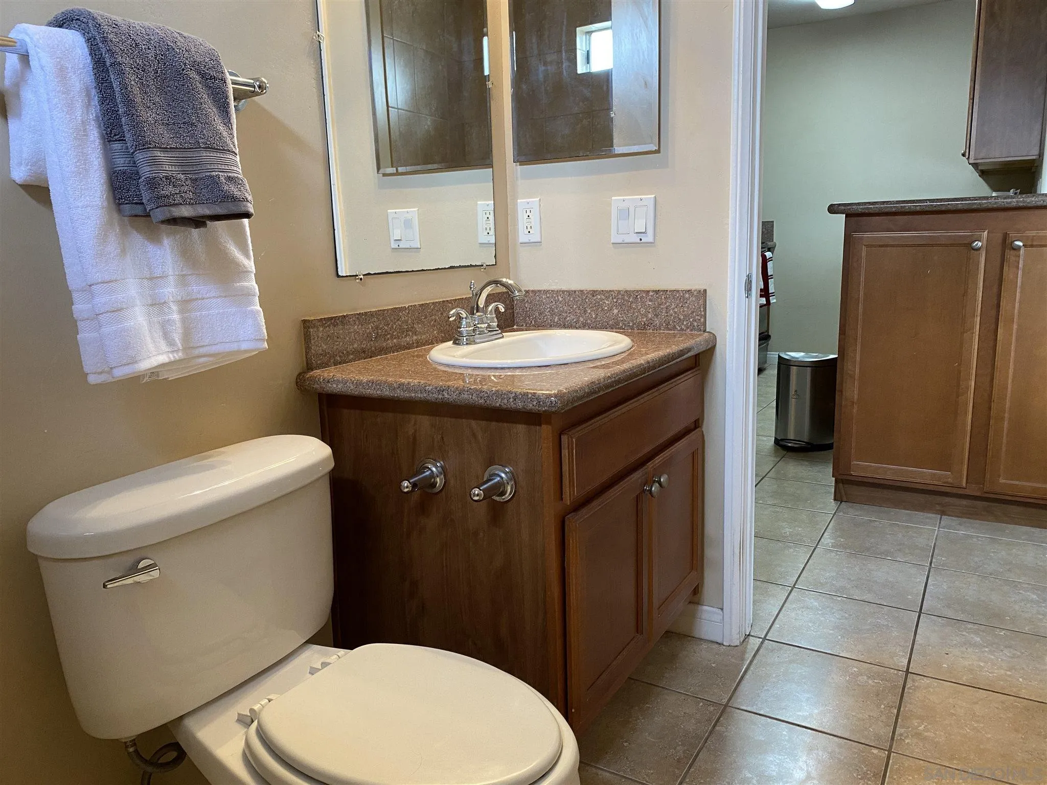 5722 Riley Street, Unit 3 San Diego, CA 92110 - Photo 10 of 14 a bathroom with a sink a toilet and mirror