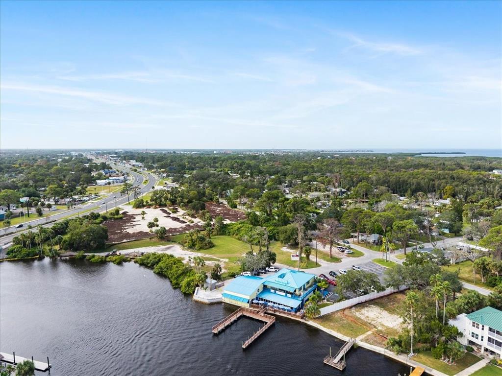 Pier Road New Port Richey, FL 34652 - Photo 14 of 17 an aerial view of residential house with outdoor space and trees all around