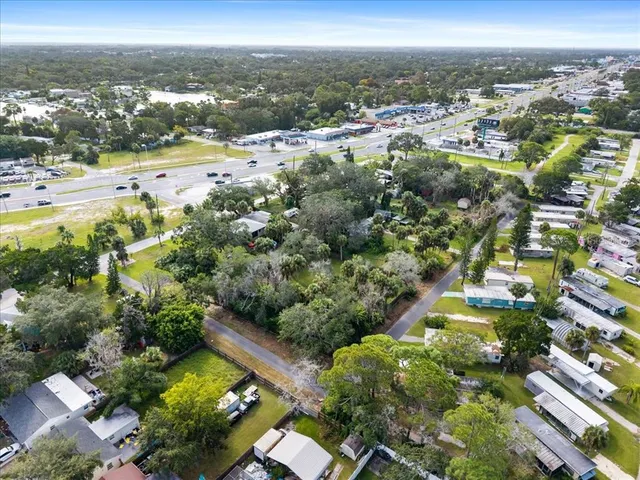 an aerial view of beach and residential houses with outdoor space
