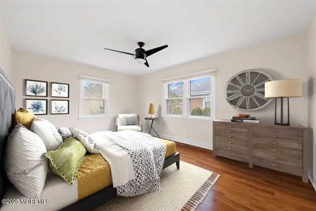 a bedroom with a bed a dresser next to a window