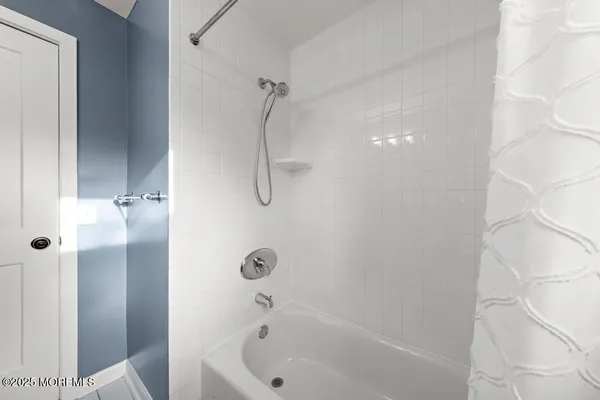 a bathroom with a bathtub and shower