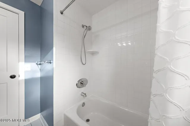 a bathroom with a bathtub and shower