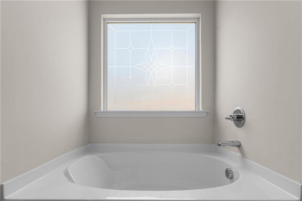 49 Thacker Trail Adairsville, GA 30103 - Photo 24 of 40 a white bath tub sitting in a bathroom next to a window