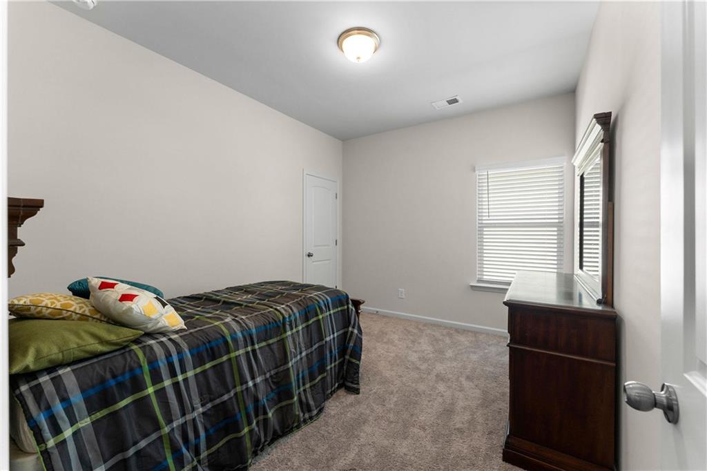 49 Thacker Trail Adairsville, GA 30103 - Photo 31 of 40 a bedroom with a bed and a window