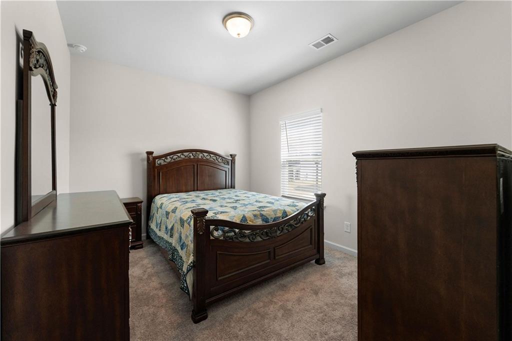 49 Thacker Trail Adairsville, GA 30103 - Photo 32 of 40 a bedroom with a bed and a window