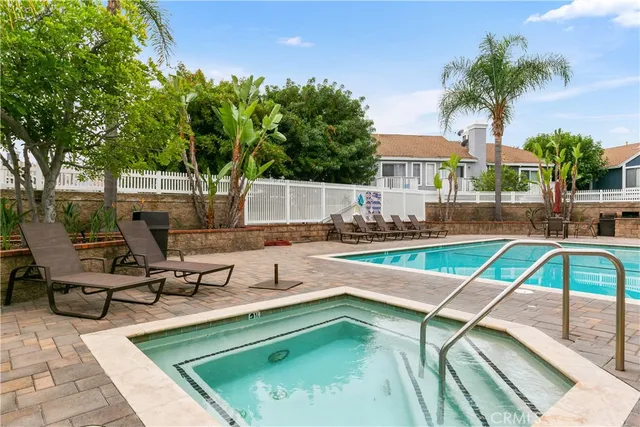 a view of a house with pool and chairs