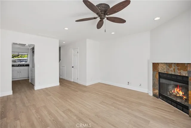 an empty room with windows and fireplace