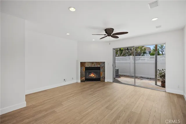a view of an empty room with a fireplace and a chandelier