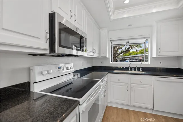 a kitchen with stainless steel appliances granite countertop a sink and a stove