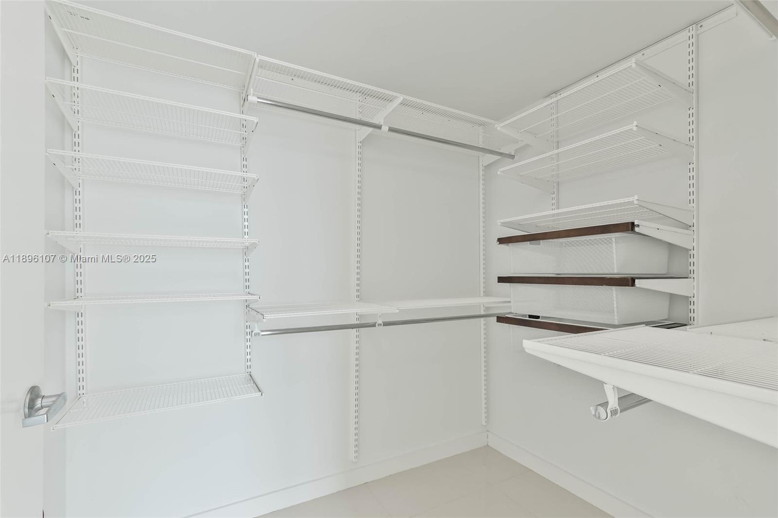 9055 Southwest 73rd Court, Unit 1402 Miami, FL 33156 - Photo 14 of 31 a kitchen with white cabinets and a sink