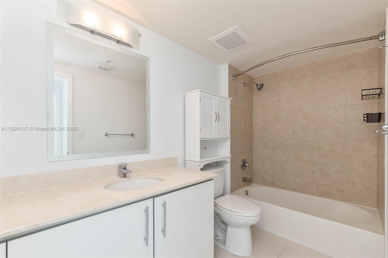 9055 Southwest 73rd Court, Unit 1402 Miami, FL 33156 - Photo 15 of 31 a bathroom with a sink a toilet and shower