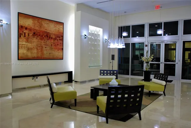 a living room with furniture and a floor to ceiling window