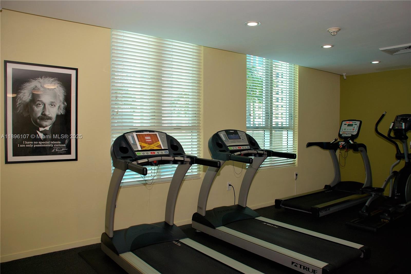 9055 Southwest 73rd Court, Unit 1402 Miami, FL 33156 - Photo 29 of 31 a room with gym equipment and a large window