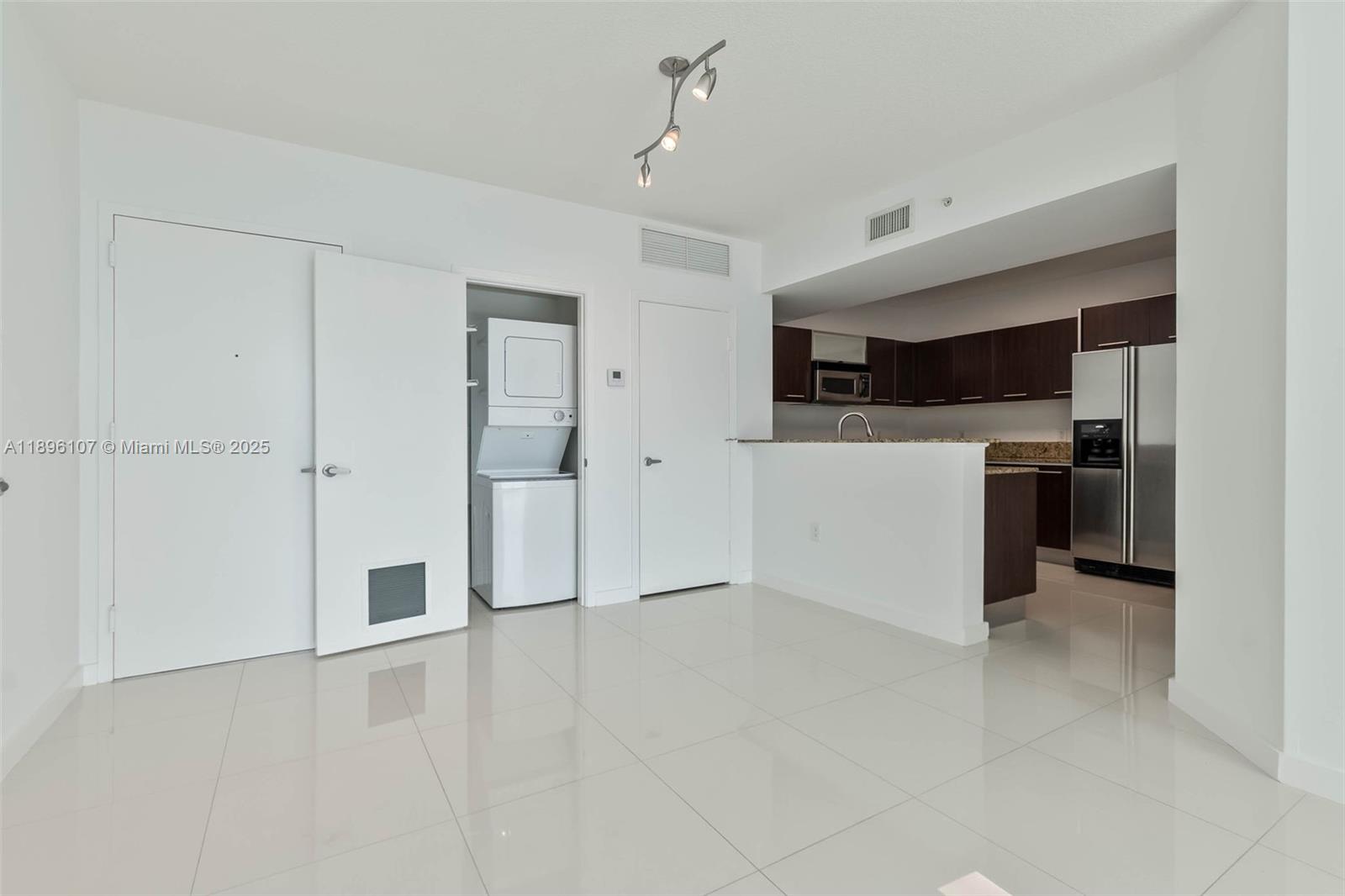 9055 Southwest 73rd Court, Unit 1402 Miami, FL 33156 - Photo 9 of 31 a view of a kitchen with refrigerator and a stove