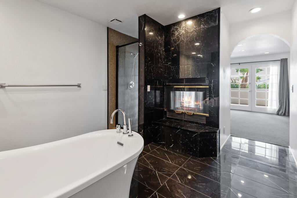 68515 Risueno Road Cathedral City, CA 92234 - Photo 14 of 29 a bathroom with a bathtub and a shower