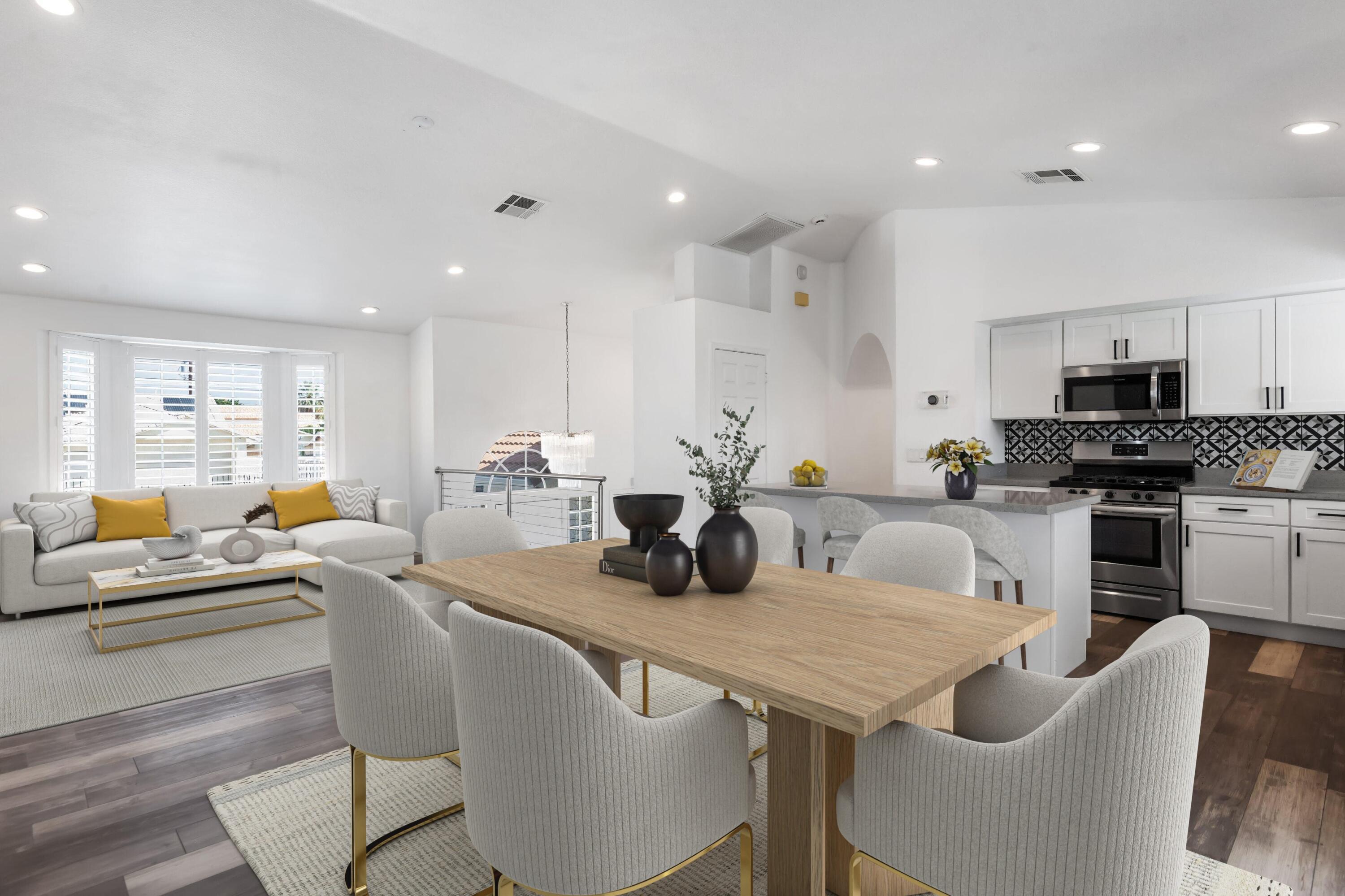 68515 Risueno Road Cathedral City, CA 92234 - Photo 4 of 29 a kitchen with stainless steel appliances granite countertop a stove a sink a dining table and chairs