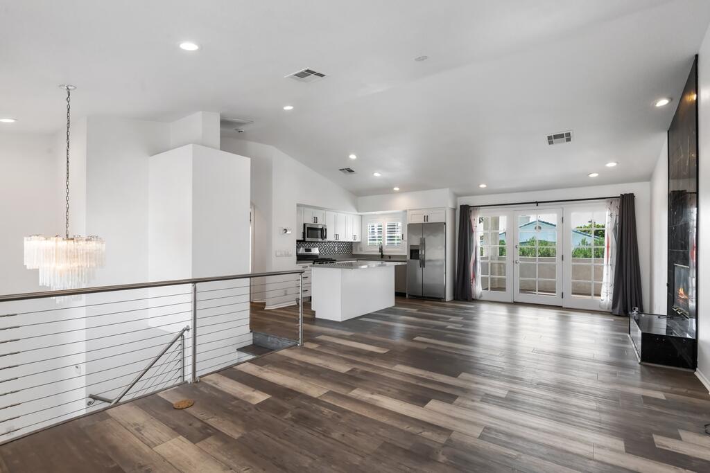68515 Risueno Road Cathedral City, CA 92234 - Photo 5 of 29 a view of a kitchen with kitchen island wooden floors and stainless steel appliances