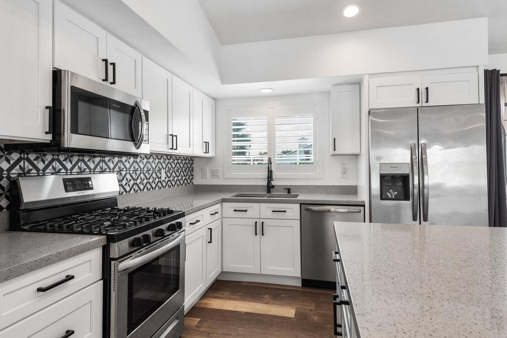 68515 Risueno Road Cathedral City, CA 92234 - Photo 9 of 29 a kitchen with stainless steel appliances granite countertop a stove a sink and a refrigerator
