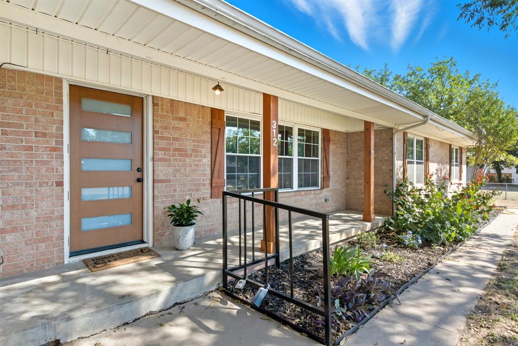 View of exterior entry featuring a porch 