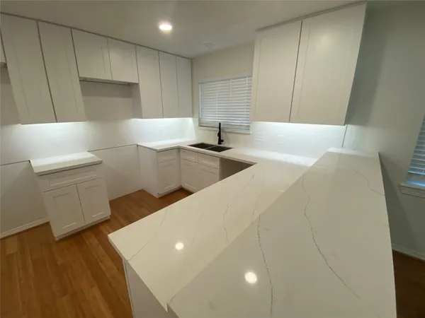 a kitchen with stainless steel appliances a sink and a refrigerator