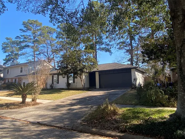 a view of a house with a yard large tree and a big yard