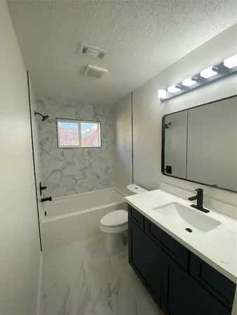a bathroom with a double vanity sink toilet and shower