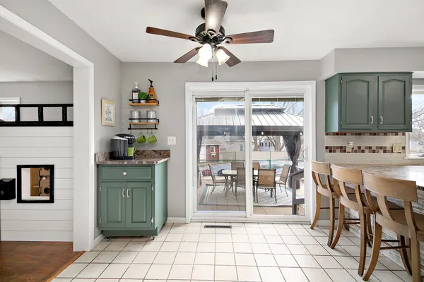 a living room with granite countertop furniture a fireplace and a chandelier