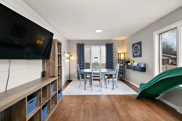 a dining room with furniture and wooden floor