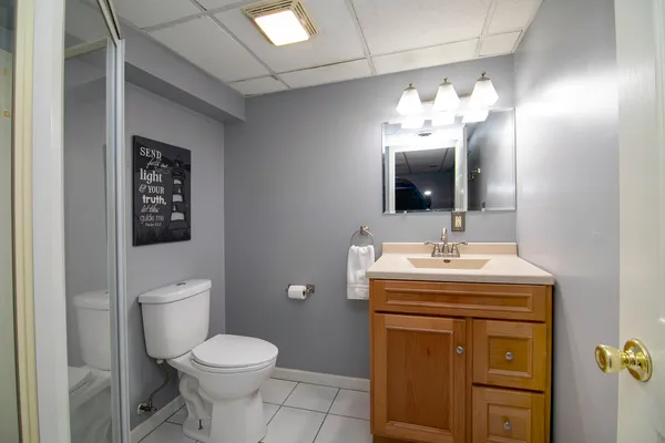 a bathroom with a toilet sink and mirror