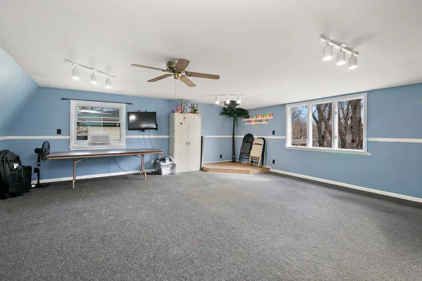 a view of a livingroom with furniture and a window