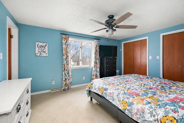 a bedroom with a bed and a chandelier