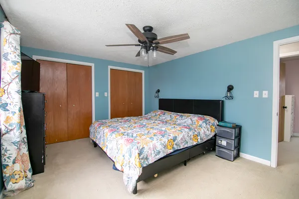a bedroom with a bed and a chandelier