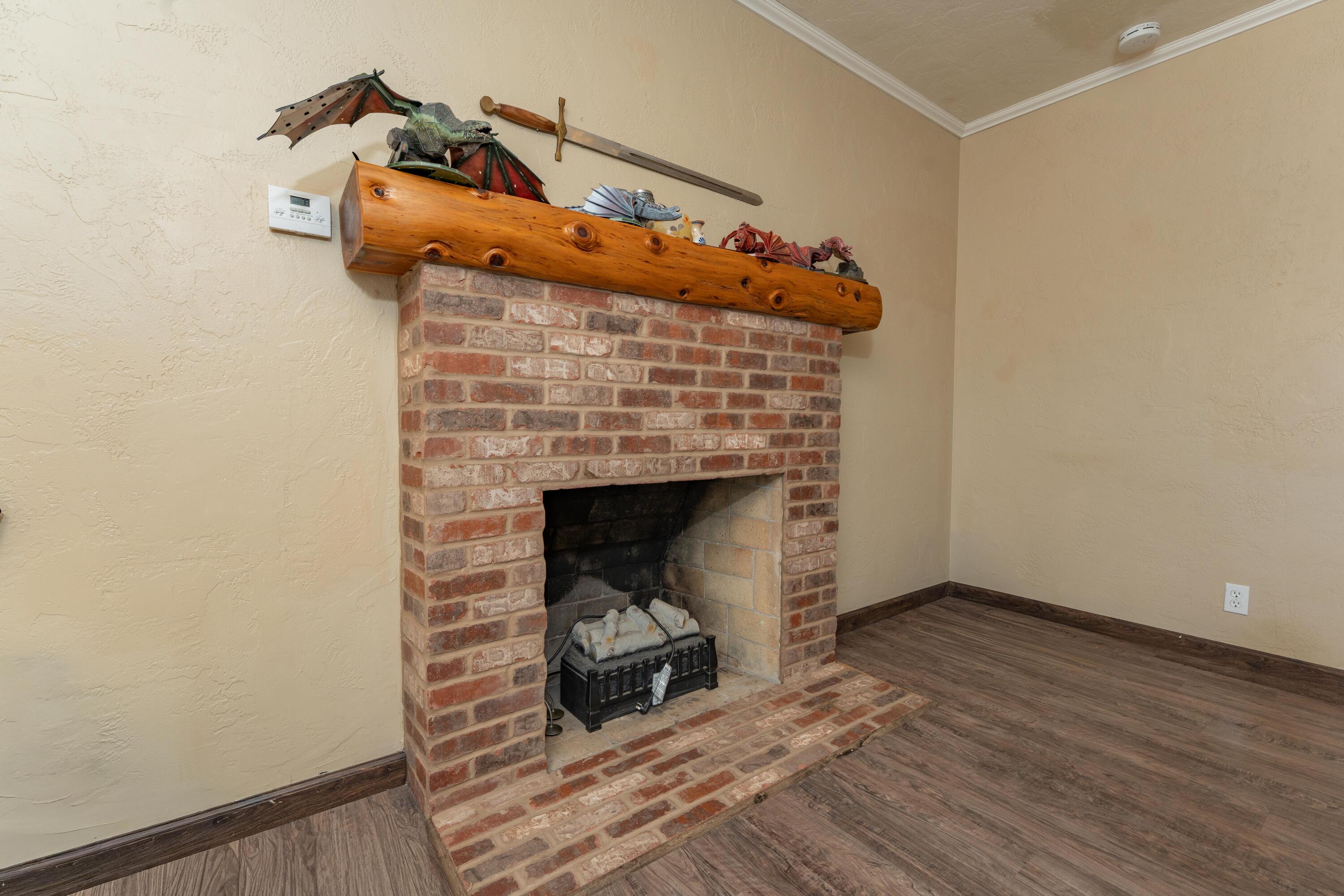570 North Birch Avenue Reedley, CA 93654 - Photo 22 of 52 a room with a fireplace and wooden floor