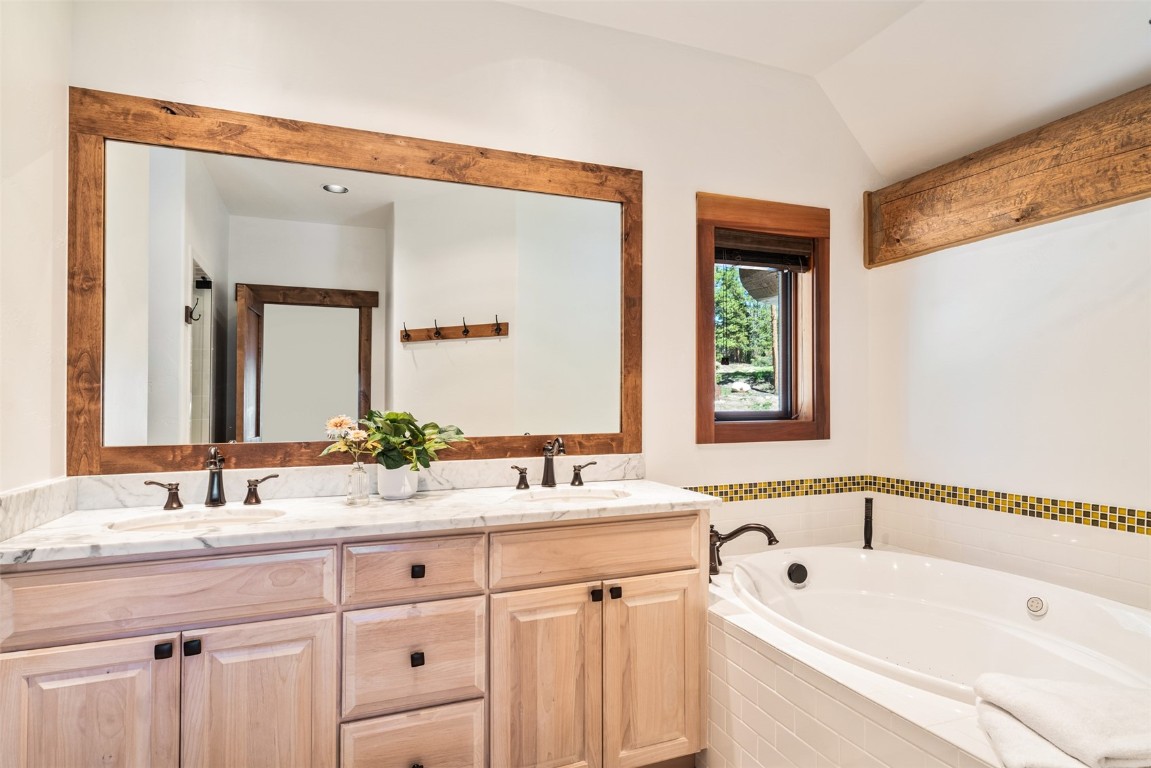 245 Easy Bend Trail Silverthorne, CO 80498 - Photo 22 of 45 a bathroom with a tub a sink and mirror
