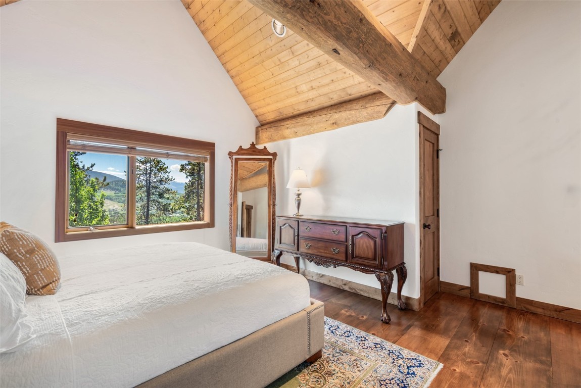 245 Easy Bend Trail Silverthorne, CO 80498 - Photo 24 of 45 a bedroom with a bed a stove and a large window