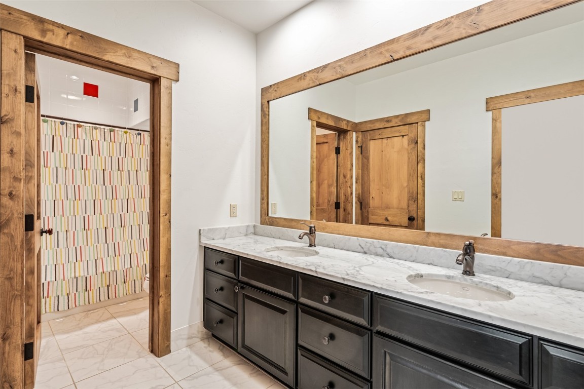 245 Easy Bend Trail Silverthorne, CO 80498 - Photo 28 of 45 a bathroom with a granite countertop sink and a mirror
