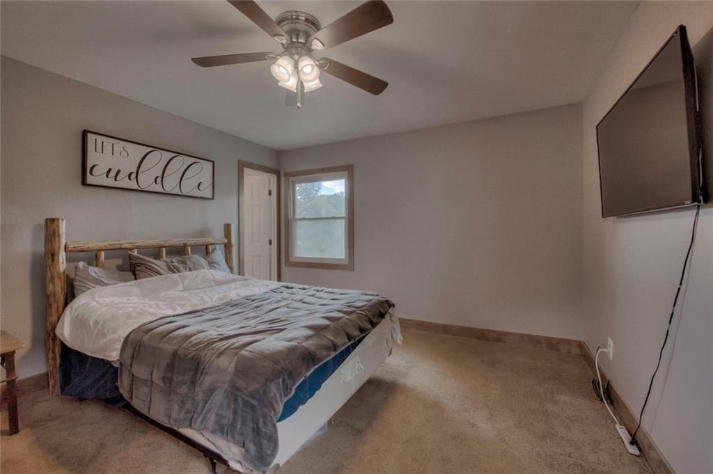 747 Deer Path Road Dillon, CO 80435 - Photo 15 of 29 a bedroom with a large bed and a tv