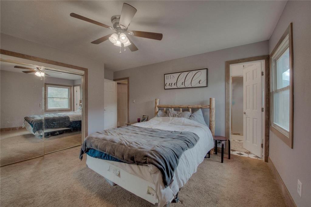 747 Deer Path Road Dillon, CO 80435 - Photo 17 of 29 a spacious bedroom with a bed and a chandelier