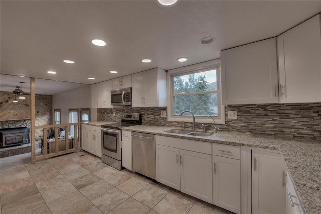 747 Deer Path Road Dillon, CO 80435 - Photo 6 of 29 a kitchen with white cabinets and sink