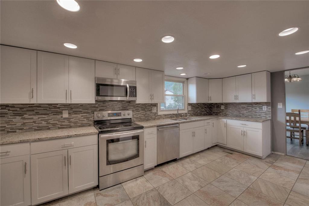 747 Deer Path Road Dillon, CO 80435 - Photo 7 of 29 a large kitchen with white cabinets stainless steel appliances and sink