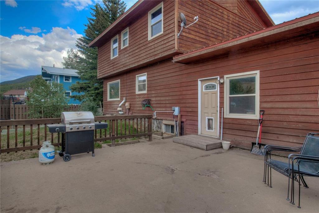 747 Deer Path Road Dillon, CO 80435 - Photo 10 of 29 a view of a house with a barbeque and wooden fence