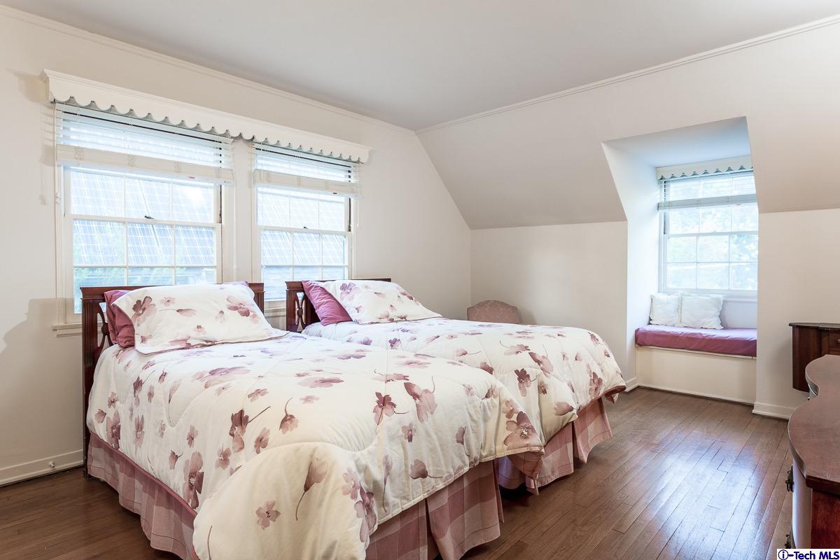 44 San Miguel Road Pasadena, CA 91105 - Photo 13 of 18 a bedroom with a bed wooden floor and window