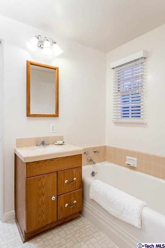 44 San Miguel Road Pasadena, CA 91105 - Photo 15 of 18 a bathroom with a tub sink and mirror