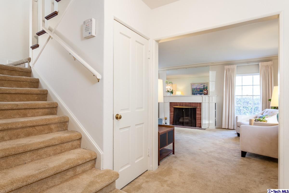 44 San Miguel Road Pasadena, CA 91105 - Photo 3 of 18 a view of a livingroom with a fireplace and staircase
